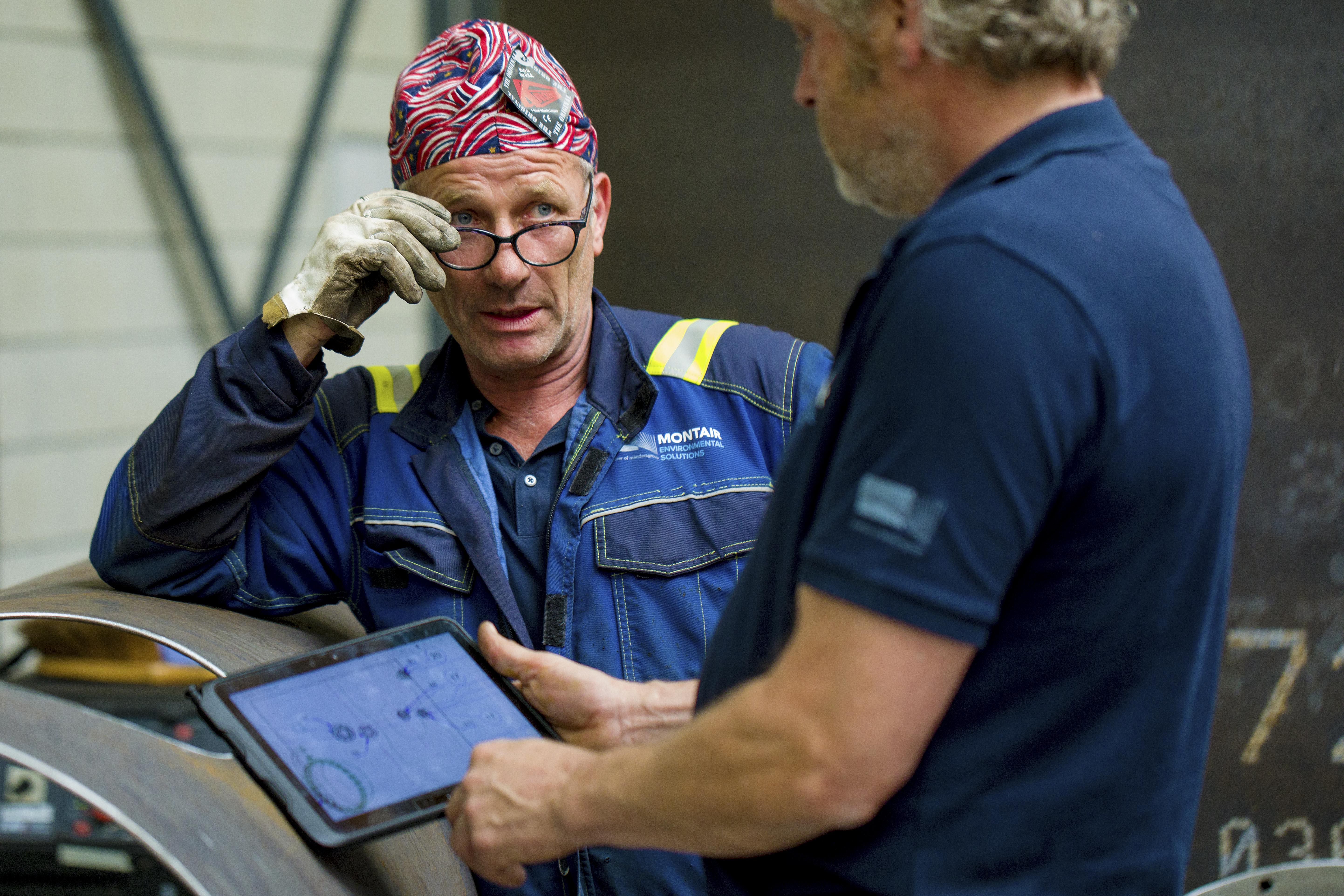 Twee collega's van Montair met een tablet in de werkplaats